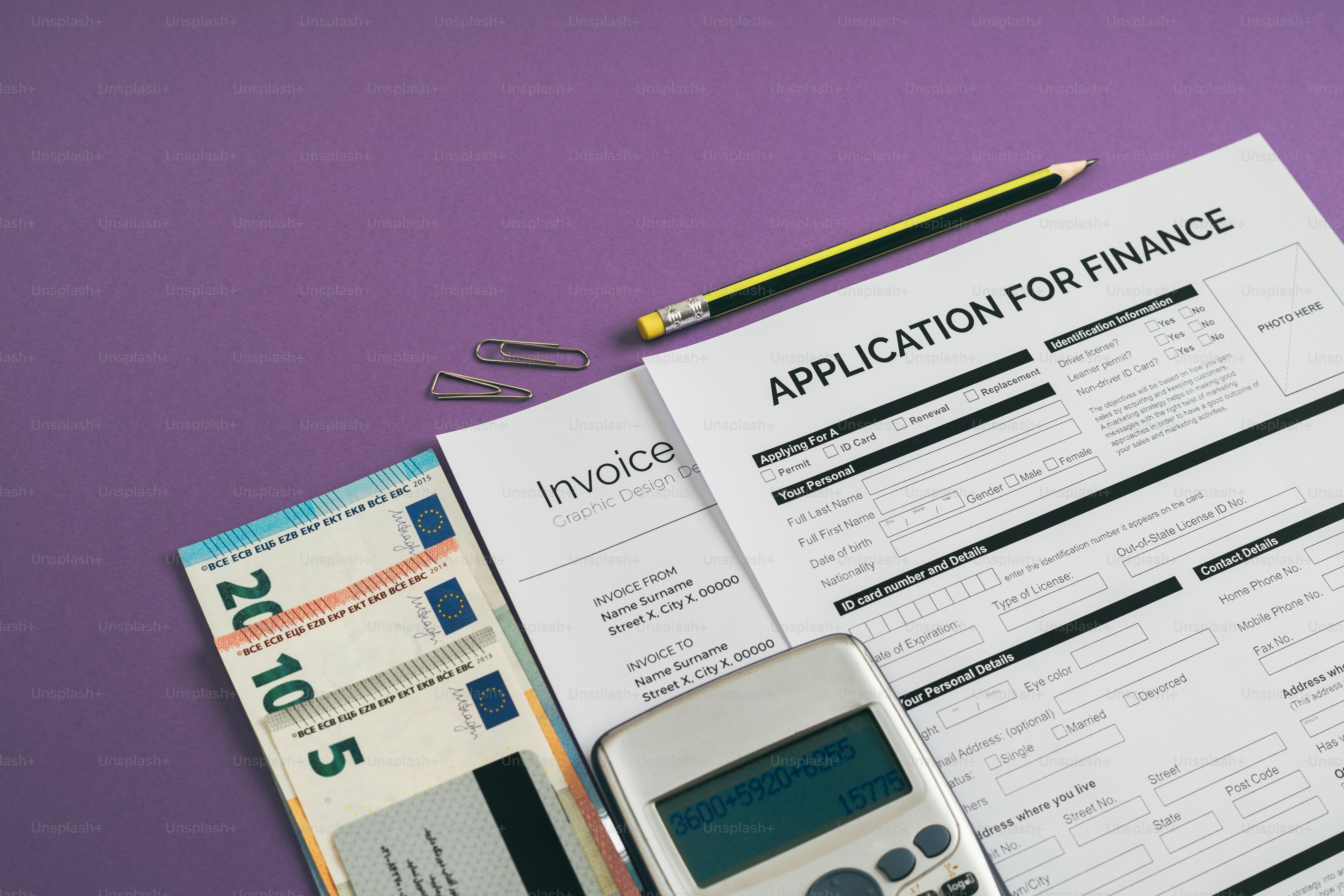 a calculator, pen, calculator and paper with application for finance